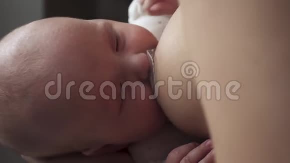 母亲喂养她熟睡的新生婴儿妈妈的牛奶母乳喂养婴儿视频的预览图