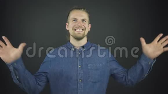 穿着蓝色牛仔衬衫的帅哥举起手来握手视频的预览图
