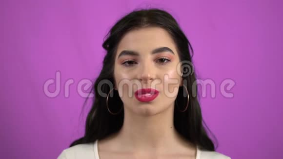 年轻性感的女人吹泡泡糖和口香糖视频的预览图