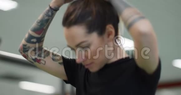 女人在健身房锻炼时休息疲惫的女人在健身休息时放松前景特写女人在热身视频的预览图