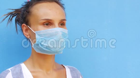 一位年轻女子正在吃药同时摘下她的防护面罩冠状病毒找到药物视频的预览图