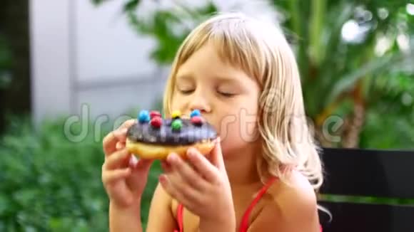 孩子吃甜甜圈百吉饼巧克力和糖果视频的预览图