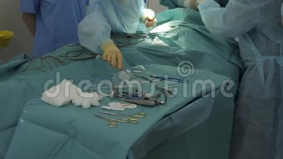手术室的外科医生用一根线缝合伤口桌子上的手术器械冠状病毒视频的预览图