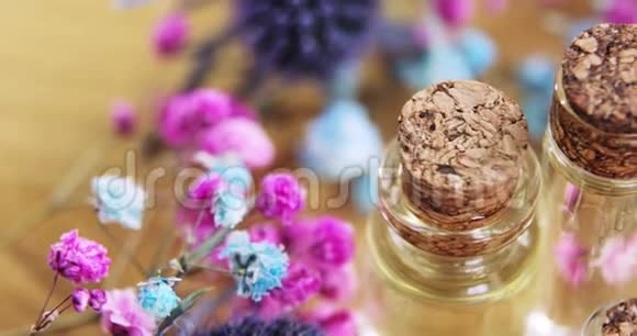 香水在玻璃瓶与软木帽之间的新鲜花特写顶部的景色视频的预览图
