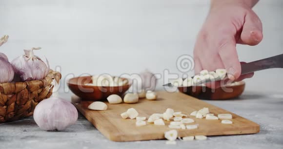 男性手从大蒜切片中清洗刀视频的预览图