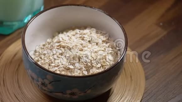 燕麦片或燕麦片放在桌上的木碗里视频的预览图