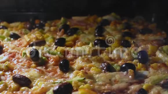 自制美味的披萨在烤箱里烤奶酪融化视频的预览图