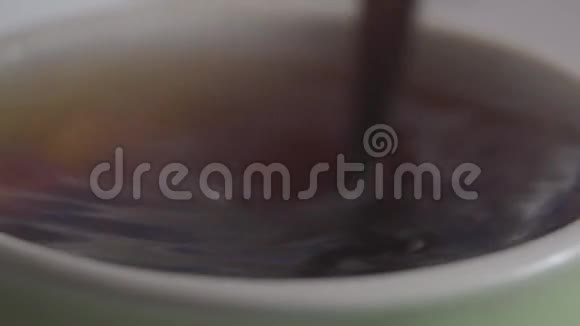 极端特写茶匙混合热饮杯中不知名的人在茶中溶解糖饮料酿造厨房视频的预览图