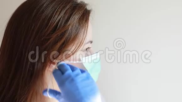 女性使用口罩保护自己免受covid19冠状病毒感染视频的预览图