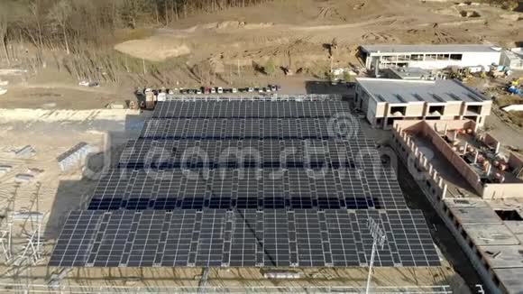 建造太阳能发电厂和安装太阳能电池板的空中盘旋视图建筑视频的预览图