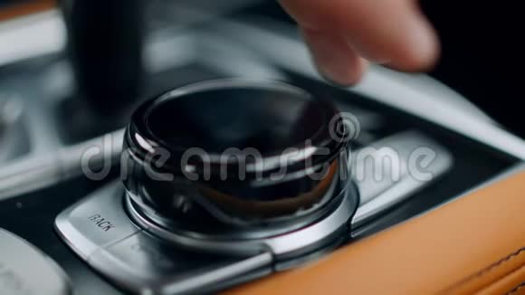近距离男子手使用控制旋钮在汽车汽车控制台手触旋钮视频的预览图