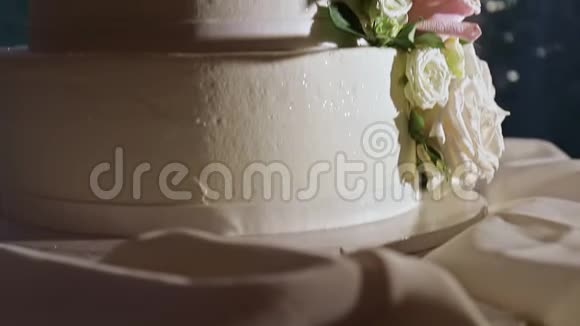 四层婚礼蛋糕和粉红色玫瑰的特写全景视频的预览图