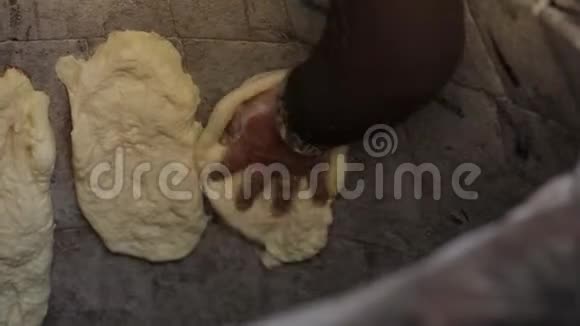 东方面包是在坦多尔煮的把面团贴在烤箱的墙壁上视频的预览图