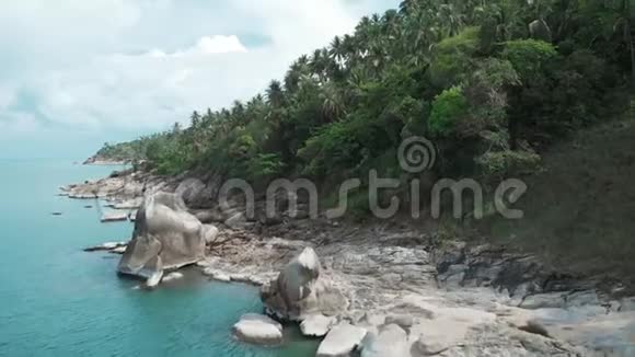 在被蓝色海水冲刷的异国热带岛屿上的鸟瞰丛林天堂浪漫度假晴朗的一天平静视频的预览图