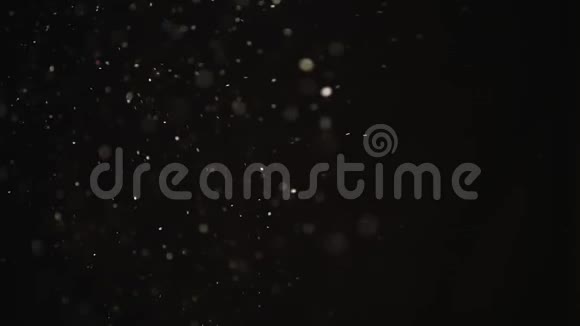 黑色背景上的天然粉尘有机漂浮颗粒空气中的灰尘为您的项目把它放下视频的预览图