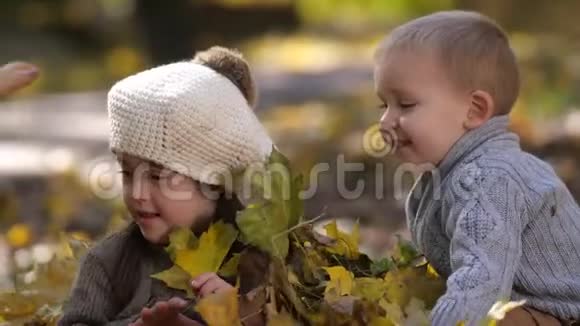 嬉戏的妈妈和带着树叶的儿子洗澡的妹妹视频的预览图