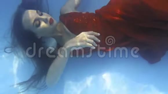 一个穿红色长裙的女人在水下游泳4k视频的预览图