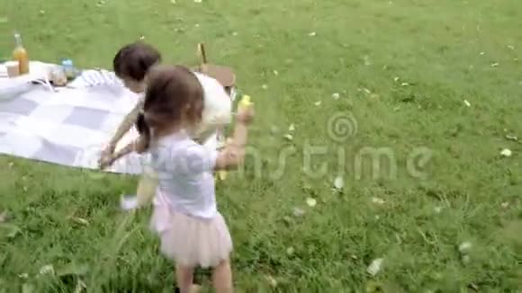可爱的孩子吹泡泡和一起在户外玩耍视频的预览图