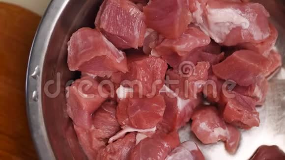 新鲜的生猪肉片放在桌子上的金属碗里红肉视频的预览图
