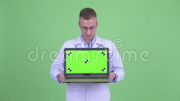 穿着男装的医生带着笔记本电脑看新闻视频的预览图