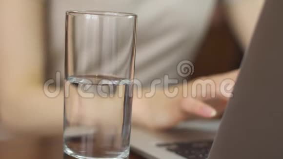 商务女性在远离家庭的电脑上工作喝水视频的预览图