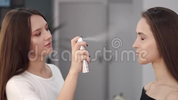 布鲁内特化妆师在美容院使用喷雾剂视频的预览图