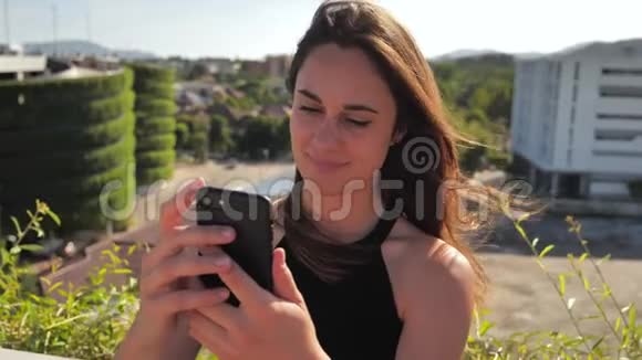 微笑女商人检查她的手机视频的预览图