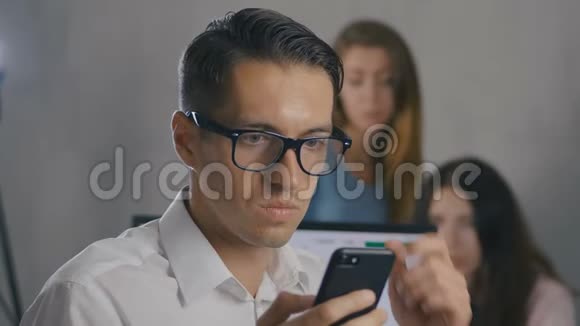 商人在智能手机上阅读一条信息时感到震惊和惊讶一个惊讶的男人摘下眼镜视频的预览图