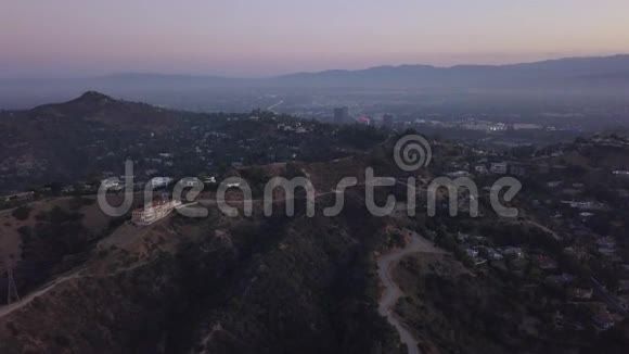 空中在日出的好莱坞山上可以看到山丘山谷和洛杉矶的电力线视频的预览图