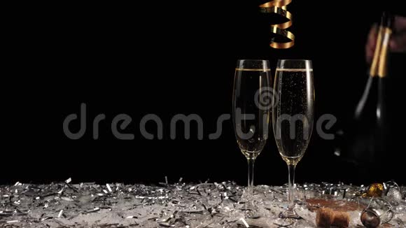 好香槟酒两杯黑背景香槟配有起泡葡萄酒的长笛手拿金瓶子视频的预览图