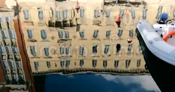 停泊在水路上的船和反映水的古建筑视频的预览图