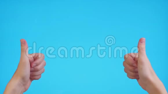 女人的双手指向交叉空间在蓝色背景上竖起大拇指视频的预览图