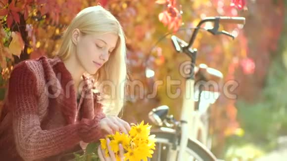 早晨和美好的一天秋天的女人穿着针织毛衣留着长发的梦幻女孩阳光明媚的公园里快乐的年轻女子视频的预览图