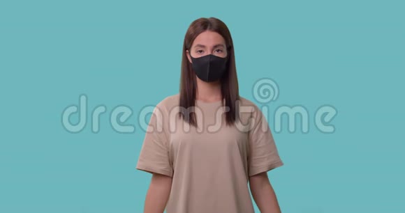 戴着医用口罩的患病妇女拿着体温计和一包药丸视频的预览图