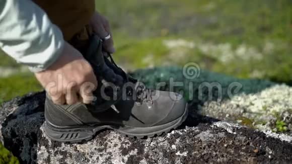 一个徒步旅行者系鞋带他在冻土带视频的预览图