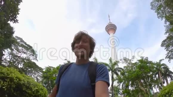 青年游客在吉隆坡生态公园制作自拍视频视频的预览图