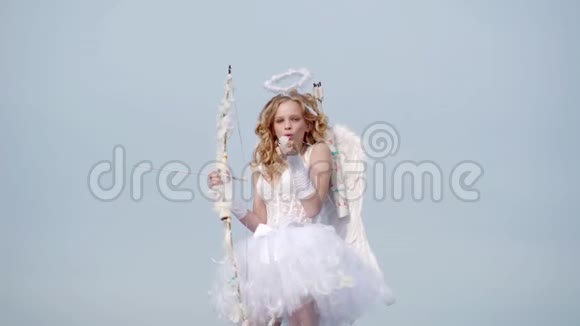 情人节天使儿童女孩有白色的翅膀可爱的天使女孩小天使女孩对抗阳光明媚的天空青少年视频的预览图