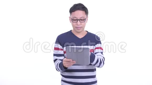 快乐的日本潮男在用数码平板电脑说话视频的预览图