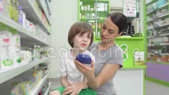 可爱的小男孩和他妈妈一起在药店购物视频的预览图