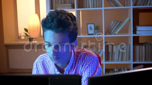 印度年轻有魅力的男程序员坐在舒适的公寓里玩电脑的特写镜头视频的预览图