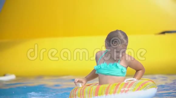 女孩在水上乐园里爬滑梯视频的预览图