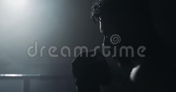 男子拳击手在黑暗中训练慢动作剪影拳击概念视频的预览图
