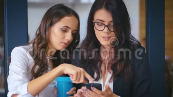 两个商务女性在办公室讨论商务项目和喝咖啡团队合作理念视频的预览图