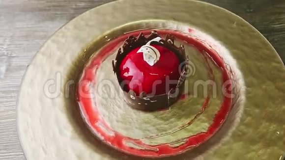 精致的甜点红釉和城堡形状的巧克力在金盘上旋转视频的预览图