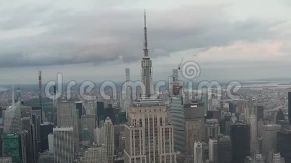 历史在阴天在繁忙的城市里被摩天大楼包围的曼哈顿帝国大厦的史诗般的外观视频的预览图