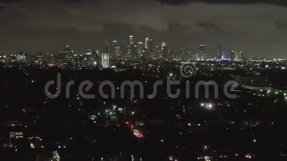 空中在黑暗的好莱坞洛杉矶上空夜幕降临乌云笼罩市中心和城市灯光视频的预览图