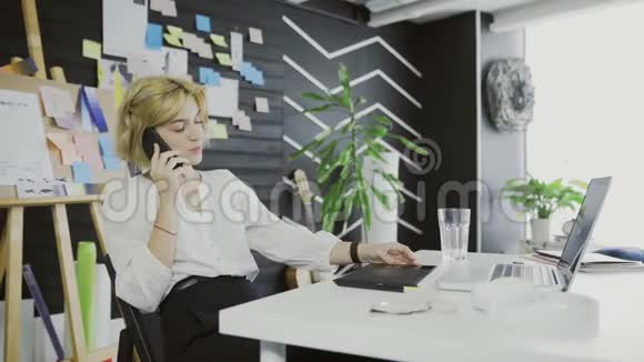 漂亮女设计师在移动电话上聊天视频的预览图