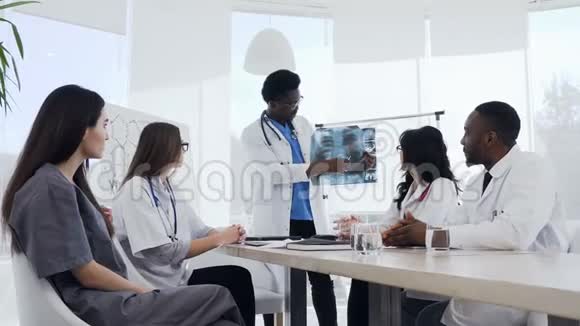 多民族青年实习生或医学生在肺心病医生讲座中展示视频的预览图
