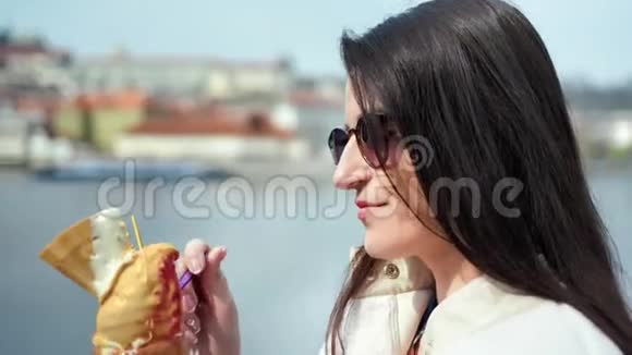 在河堤上享受户外冰淇淋甜点的亲密快乐可爱的女人放松和微笑视频的预览图
