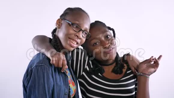两个年轻的非洲裔美国妇女拥抱和微笑的镜头快乐孤立的白色背景黑人朋友视频的预览图